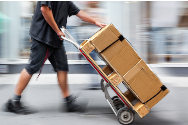 Man carrying boxes on a hand dolly