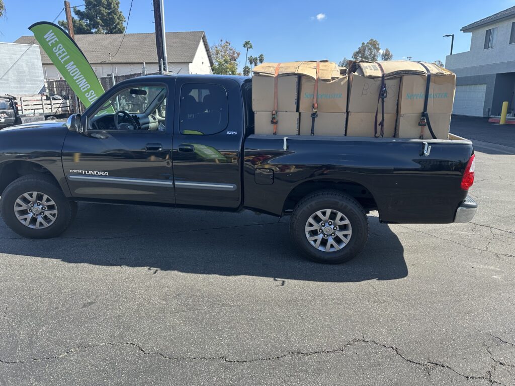 Truck full of boxes strapped down with ratchet straps