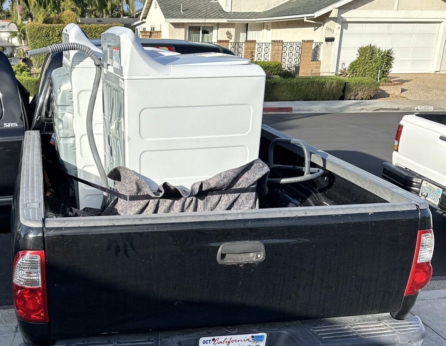 Washer and dryer strapped down in a pickup truck bed and delivered to Fountain Valley, CA.