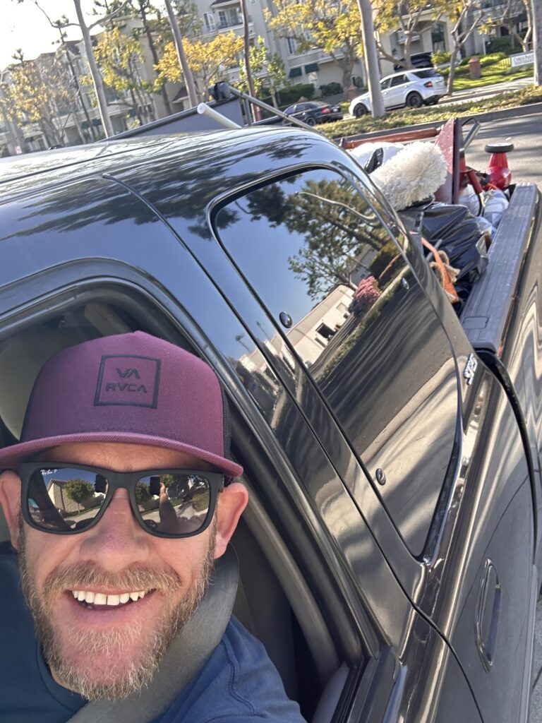 man in loaded moving truck. Just a guy and his truck.