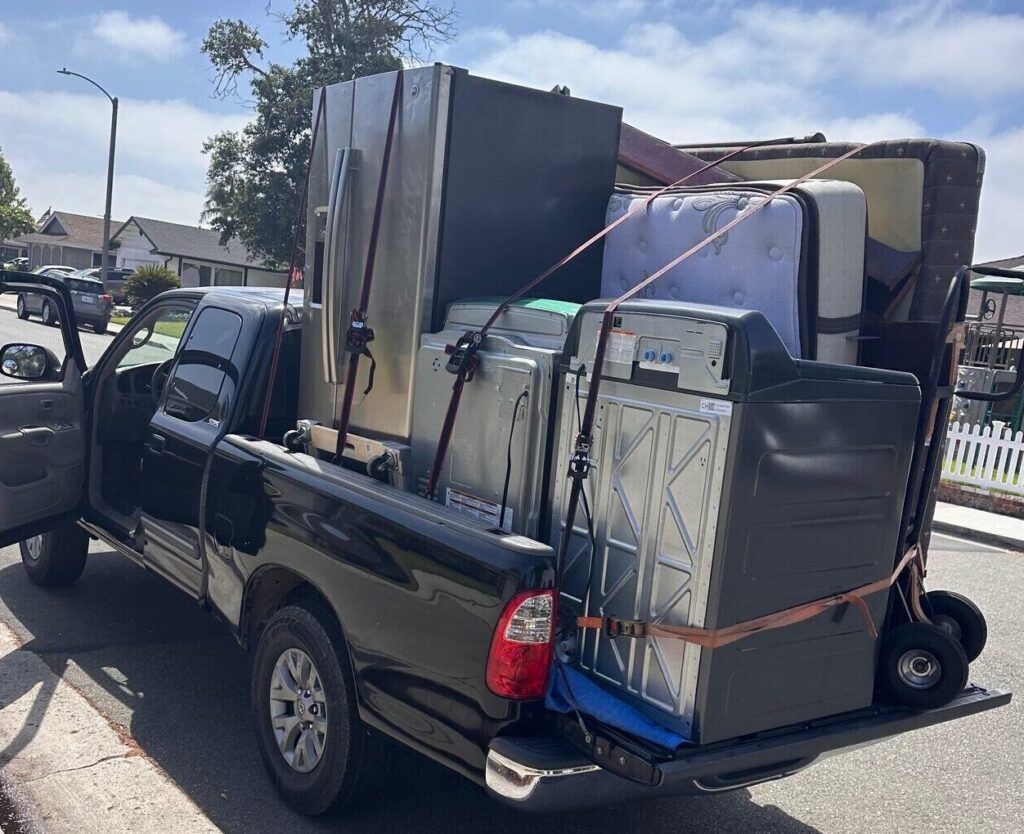 Refrigerator, washer and dryer loaded and strapped into a pickup truck bed and delivered in Orange, CA.