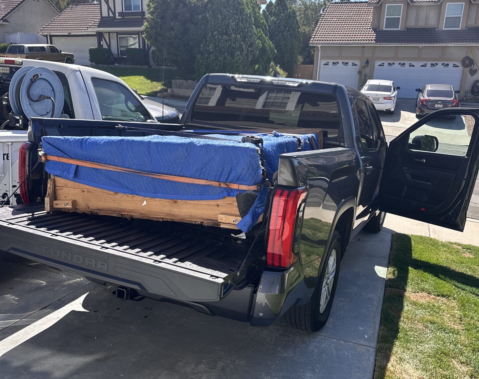 Pickup truck at curb picking up marketplace item.